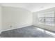 Bright bedroom with a large window and neutral carpet, ready for personalization at 6625 Story Cir, Norcross, GA 30093
