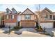 Charming townhome featuring a brick and siding exterior, attached garage, and well-maintained landscaping at 6625 Story Cir, Norcross, GA 30093