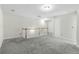 Bright bonus room with neutral walls and carpet features a wood-trimmed staircase at 6625 Story Cir, Norcross, GA 30093
