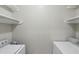 Laundry room with a washer, dryer, and shelving providing functional space for laundry needs at 1250 Parkwood Se Cir # 2201, Atlanta, GA 30339