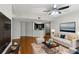 Bright living room featuring hardwood floors, a ceiling fan, and a view of the kitchen at 1250 Parkwood Se Cir # 2201, Atlanta, GA 30339