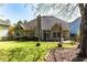 Spacious backyard with a well-maintained lawn, mature trees, and outdoor seating, perfect for entertaining at 1630 Chadwick Mill Ln, Lawrenceville, GA 30043