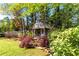 Charming backyard featuring a garden shed, lush landscaping, and a tranquil outdoor setting at 1630 Chadwick Mill Ln, Lawrenceville, GA 30043