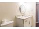 Bathroom featuring a vanity with marble countertop and a round mirror at 1630 Chadwick Mill Ln, Lawrenceville, GA 30043