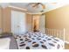 A spacious bedroom with hardwood floors, a ceiling fan and a double door closet at 1630 Chadwick Mill Ln, Lawrenceville, GA 30043