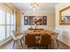 Elegant dining room featuring stylish furniture, a modern light fixture, and natural light from shuttered windows at 1630 Chadwick Mill Ln, Lawrenceville, GA 30043