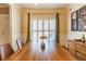 Elegant dining room with a large wooden table, matching sideboard, and sunlit windows at 1630 Chadwick Mill Ln, Lawrenceville, GA 30043