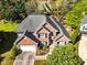 Stunning brick home featuring a two-car garage and lush landscaping, perfect for curb appeal at 1630 Chadwick Mill Ln, Lawrenceville, GA 30043