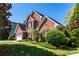 A beautiful brick home with lush greenery, offering a welcoming and picturesque view at 1630 Chadwick Mill Ln, Lawrenceville, GA 30043