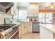 Kitchen boasts stainless steel appliances, marble countertops, and abundant cabinet space at 1630 Chadwick Mill Ln, Lawrenceville, GA 30043