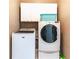 A dedicated laundry room with modern machines and overhead storage at 1630 Chadwick Mill Ln, Lawrenceville, GA 30043