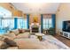Bright living room features a fireplace, hardwood floors, modern furniture, and lots of natural light at 1630 Chadwick Mill Ln, Lawrenceville, GA 30043