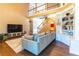 Spacious living room features hardwood floors, a bookshelf, and an open floor plan at 1630 Chadwick Mill Ln, Lawrenceville, GA 30043