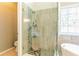 Stylish shower with glass enclosure, stone accents, a rainfall showerhead, and a built-in seat at 1630 Chadwick Mill Ln, Lawrenceville, GA 30043