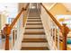 Beautiful staircase with wooden steps, white risers, and a contrasting wooden handrail at 1630 Chadwick Mill Ln, Lawrenceville, GA 30043