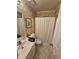 Full bathroom featuring tiled floors, vanity, and shower with a shower curtain at 1910 Cooper Landing Se Dr, Smyrna, GA 30080
