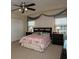 Cozy bedroom with a ceiling fan, light pink comforter, neutral carpet, and natural light at 310 Brittany Ct, Duluth, GA 30096