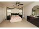 Comfortable bedroom with a queen-size bed, dark wood dressers, neutral carpet, and double closet at 310 Brittany Ct, Duluth, GA 30096