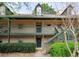 Inviting two-story apartment exterior featuring a cozy entrance and well-maintained green surroundings at 310 Brittany Ct, Duluth, GA 30096