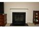 Elegant fireplace with white mantel, complemented by dark tile and a cabinet with display items at 310 Brittany Ct, Duluth, GA 30096