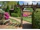 Inviting garden entrance with brick path, gazebo, bench, and blooming azaleas creating a serene outdoor space at 310 Brittany Ct, Duluth, GA 30096