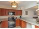Traditional style kitchen features dark wood cabinetry, modern appliances, and durable gray countertops at 310 Brittany Ct, Duluth, GA 30096