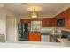 Well-lit kitchen featuring wooden cabinets, modern appliances, and a countertop bar area at 310 Brittany Ct, Duluth, GA 30096