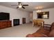 Cozy living room with a fireplace, carpeted floor, and a dining area with a wooden table at 310 Brittany Ct, Duluth, GA 30096