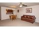 Spacious living room featuring a comfortable leather couch, chandelier, and an open view to the kitchen at 310 Brittany Ct, Duluth, GA 30096