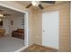 Cozy sunroom with a ceiling fan, door, and an adjoining living room with comfortable furniture at 310 Brittany Ct, Duluth, GA 30096