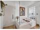 Bathroom with soaking tub, glass-enclosed shower, and bright natural light at 3235 Roswell Ne Rd # 508, Atlanta, GA 30305