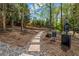 Well-maintained community dog park featuring a stone path, mature trees, and waste disposal station at 3235 Roswell Ne Rd # 508, Atlanta, GA 30305