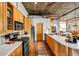 A modern kitchen with stainless steel appliances, wooden cabinets, and concrete ceilings at 3235 Roswell Ne Rd # 508, Atlanta, GA 30305
