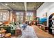 Spacious living room features exposed brick, ductwork, hardwood floors, and modern furnishings at 3235 Roswell Ne Rd # 508, Atlanta, GA 30305