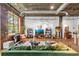 Stylish living room featuring exposed brick, concrete ceilings, large windows, and a comfortable green sectional at 3235 Roswell Ne Rd # 508, Atlanta, GA 30305