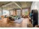 Spacious living room with exposed brick, high ceilings and an open floor plan bathed in natural light at 3235 Roswell Ne Rd # 508, Atlanta, GA 30305