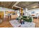 Spacious living area with exposed ductwork, hardwood floors, and a modern kitchen and bedroom at 3235 Roswell Ne Rd # 508, Atlanta, GA 30305