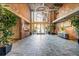 Bright lobby featuring brick walls, tile floors, plants, and a chandelier at 3235 Roswell Ne Rd # 508, Atlanta, GA 30305
