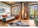 Bright bedroom with exposed brick, offering a private balcony and tranquil views of nature at 3235 Roswell Ne Rd # 508, Atlanta, GA 30305