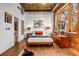 A charming bedroom with brick walls, hardwood floors, and lots of natural light at 3235 Roswell Ne Rd # 508, Atlanta, GA 30305