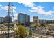 A distant view of a city skyline with lush green trees in the foreground on a partly cloudy day at 3235 Roswell Ne Rd # 508, Atlanta, GA 30305