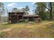 Backyard of a home with greenery, a screened porch, and a lush landscape at 758 Lauren Cir, Lawrenceville, GA 30043
