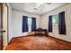 Neutral bedroom with wood trim, large windows, and dark accent curtains at 758 Lauren Cir, Lawrenceville, GA 30043