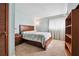 Cozy bedroom featuring neutral carpet, a wood-framed bed, and plenty of natural light at 758 Lauren Cir, Lawrenceville, GA 30043