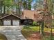 Charming two-story home with a brick chimney, attached garage, and wooded lot at 758 Lauren Cir, Lawrenceville, GA 30043