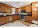 Well-equipped kitchen featuring stainless steel appliances, wood cabinets, and tiled backsplash at 758 Lauren Cir, Lawrenceville, GA 30043