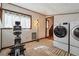 Well-equipped laundry area with washer, dryer, exercise machine, and window at 758 Lauren Cir, Lawrenceville, GA 30043