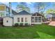 Charming backyard featuring a quaint white cottage, screened-in porch and a storage shed at 2930 Ringle Rd, Brookhaven, GA 30341