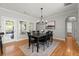Open dining area featuring modern chandelier, hardwood floors, and backyard access at 2930 Ringle Rd, Brookhaven, GA 30341