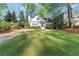 Well-maintained lawn with a cozy traditional-style home nestled among mature trees and landscaping at 2930 Ringle Rd, Brookhaven, GA 30341